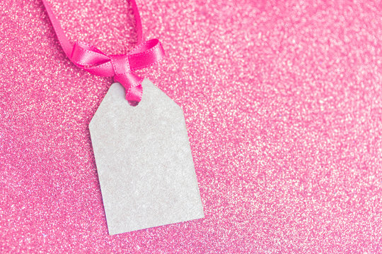 Blank tag tied with pink ribbon. Price tag, gift tag, sale tag, address label.