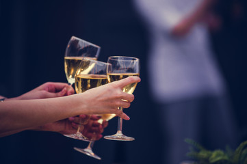 Cheers! Group of people cheering with champagne flutes with party background, Concept Celebration.