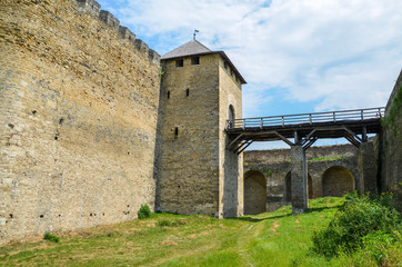 Fototapeta na wymiar Bridge over the moat and gate to the Khotyn Fortress, Ukraine