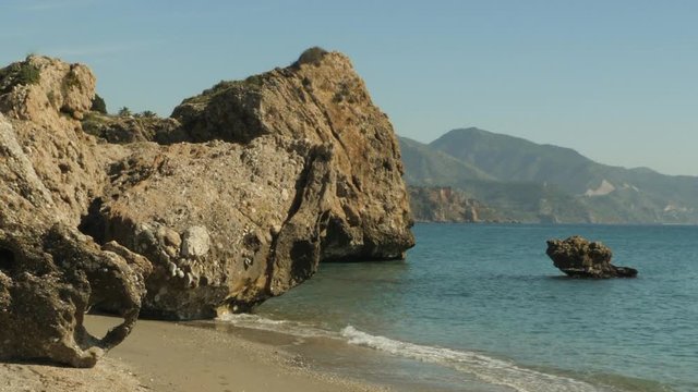 Scenic seascape landscape view at iconic rocky beach in Nerja, Spain