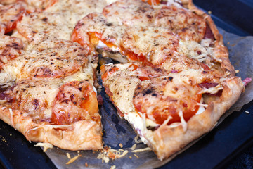Step 7. Making pizza with sausage. Sliced slice of pizza, lies nearby. Italian cuisine