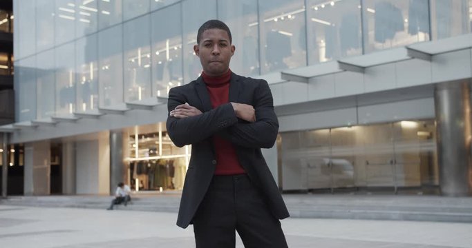 attractive black Hispanic young guy male businessman successful manager in a classic suit posing and looking at camera 