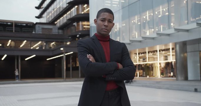 attractive black Hispanic young guy male businessman successful manager in a classic suit posing and looking at camera 