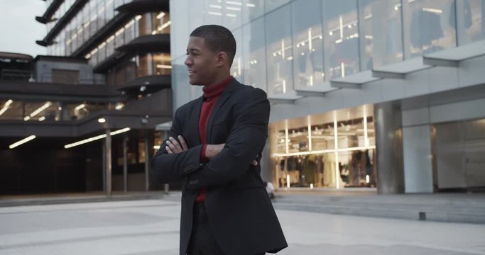 attractive happy black Hispanic young guy male businessman successful manager in a classic suit looking at camera