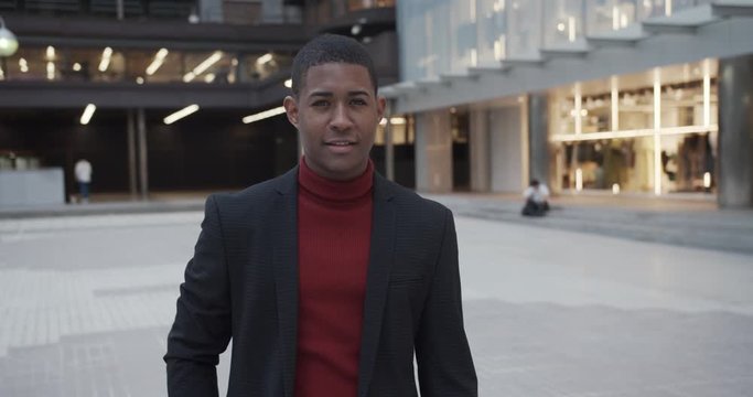 attractive happy black Hispanic young guy male businessman successful manager in a classic suit looking at camera