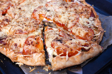 Step 7. Making pizza with sausage. Sliced slice of pizza, lies nearby. Italian cuisine