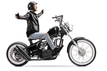 Fototapeta na wymiar Young biker riding a custom chopper motorbike without hands