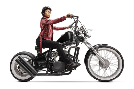 Young woman riding a custom black motorcycle