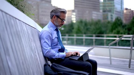 50 years old entrepreneur formally dressed communicating via mobile app while working with report via online platform in browser, man having international smartphone conversation on urban setting