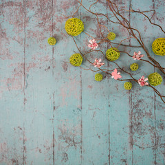 Spring decorations on the wooden background. Some branches, butterflies and more