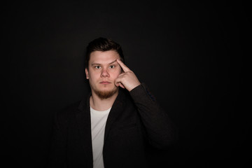 Portrait of young amazed man isolated on gray background