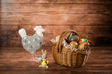 Easter eggs in a basket. Easter decoration. On the wooden background
