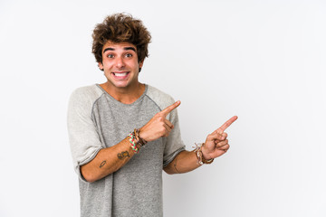 Young caucasian man against a white background isolated shocked pointing with index fingers to a...