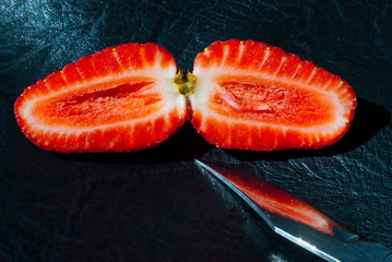 Ripe strawberries in the cut, knife.