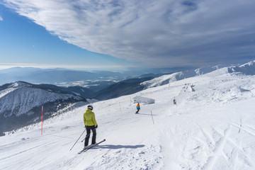 Fototapeta na wymiar Skiers on a slope in the mountains of Slovakia