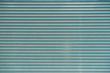Fototapeta premium old blue shutter metal door background with text space
