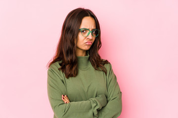 Young mixed race hispanic woman isolated frowning face in displeasure, keeps arms folded.
