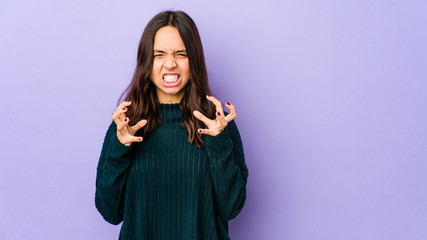 Young mixed race hispanic woman isolated upset screaming with tense hands.