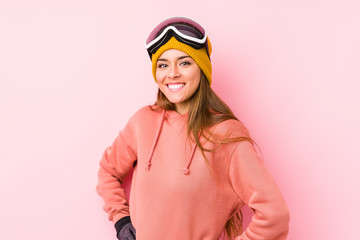 Young caucasian woman wearing a ski clothes isolated confident keeping hands on hips.