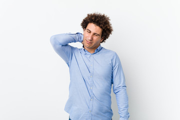 Young curly mature man wearing an elegant shirt suffering neck pain due to sedentary lifestyle.