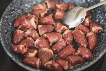 Process of cooking fried roasted grilled chicken hearts with sour cream, fresh raw stewed chicken hearts