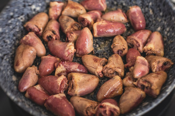 Process of cooking fried roasted grilled chicken hearts with sour cream, fresh raw stewed chicken hearts