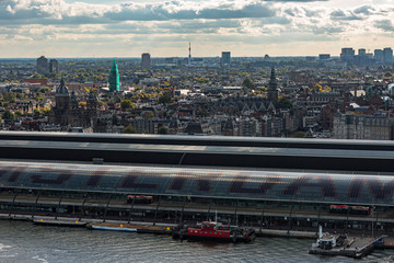 Central train station of Amsterdam, The Netherlands, seen from the other side of the river IJ with historic centre in the background