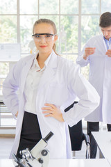 Obraz premium Male and female scientists working in a science laboratory with various equipment in the laboratory.