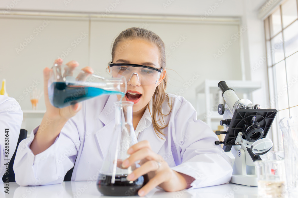 Poster A beautiful female scientist is operating in a science lab with various equipment in the lab.