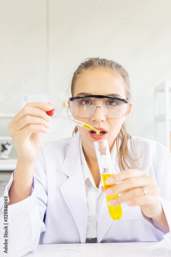 Poster A beautiful female scientist is operating in a science lab with various equipment in the lab.