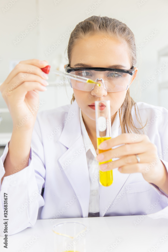 Poster A beautiful female scientist is operating in a science lab with various equipment in the lab.