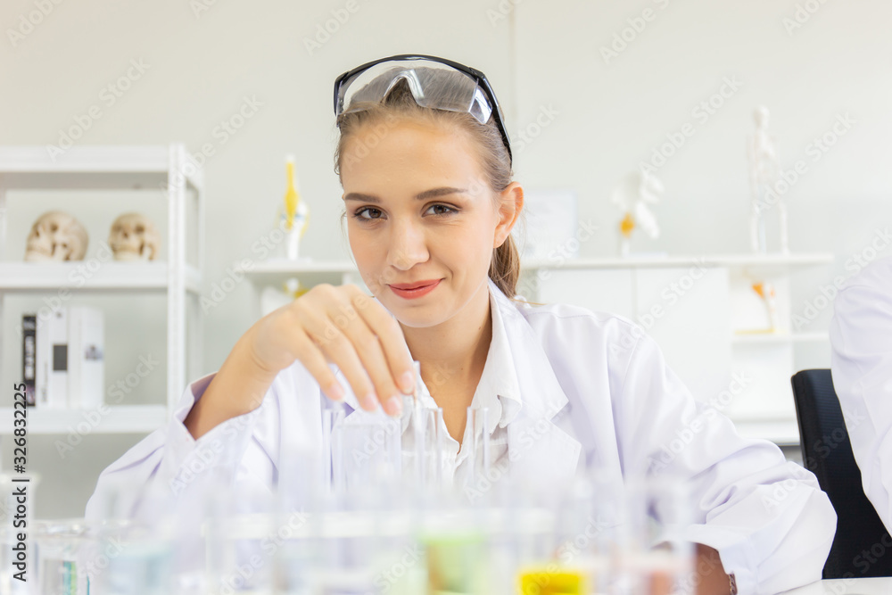 Poster A beautiful female scientist is operating in a science lab with various equipment in the lab.