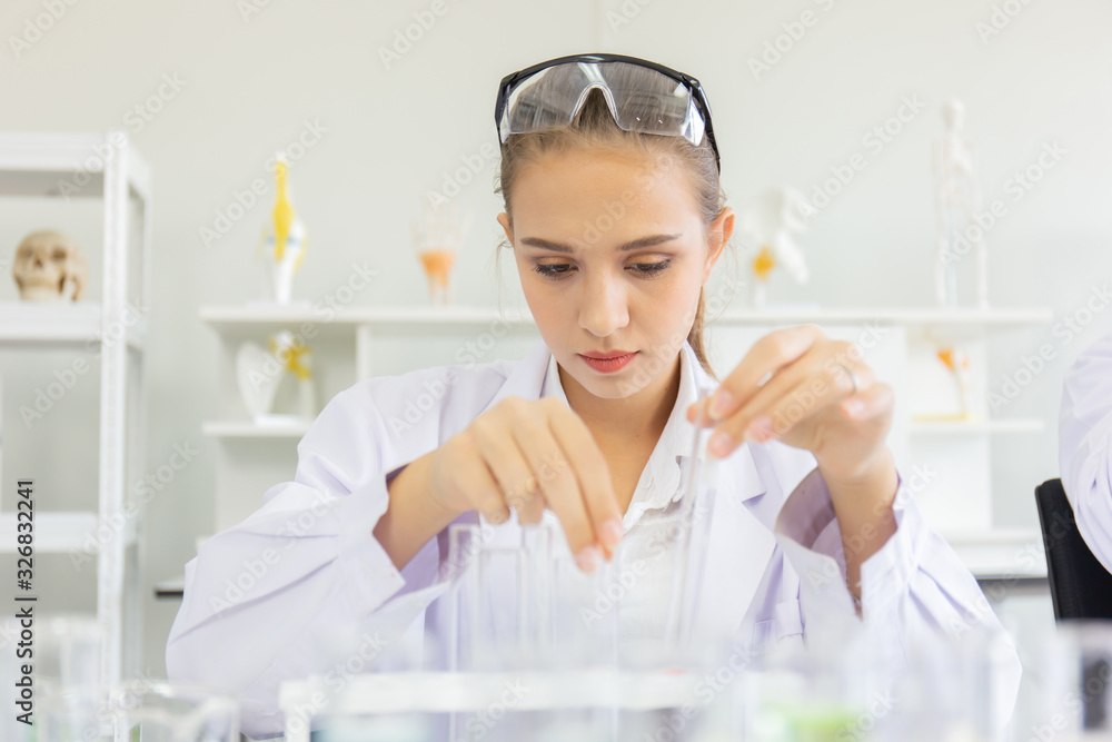 Poster A beautiful female scientist is operating in a science lab with various equipment in the lab.