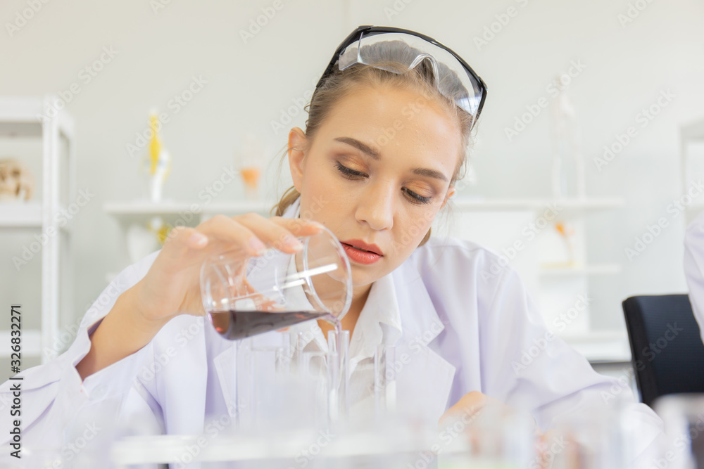 Poster A beautiful female scientist is operating in a science lab with various equipment in the lab.