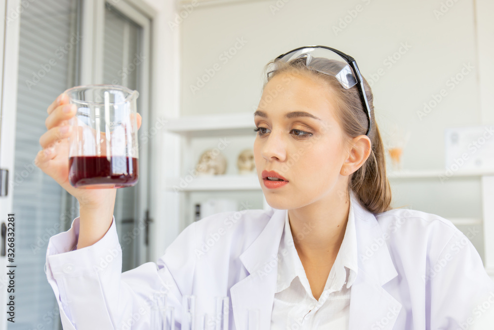 Poster A beautiful female scientist is operating in a science lab with various equipment in the lab.