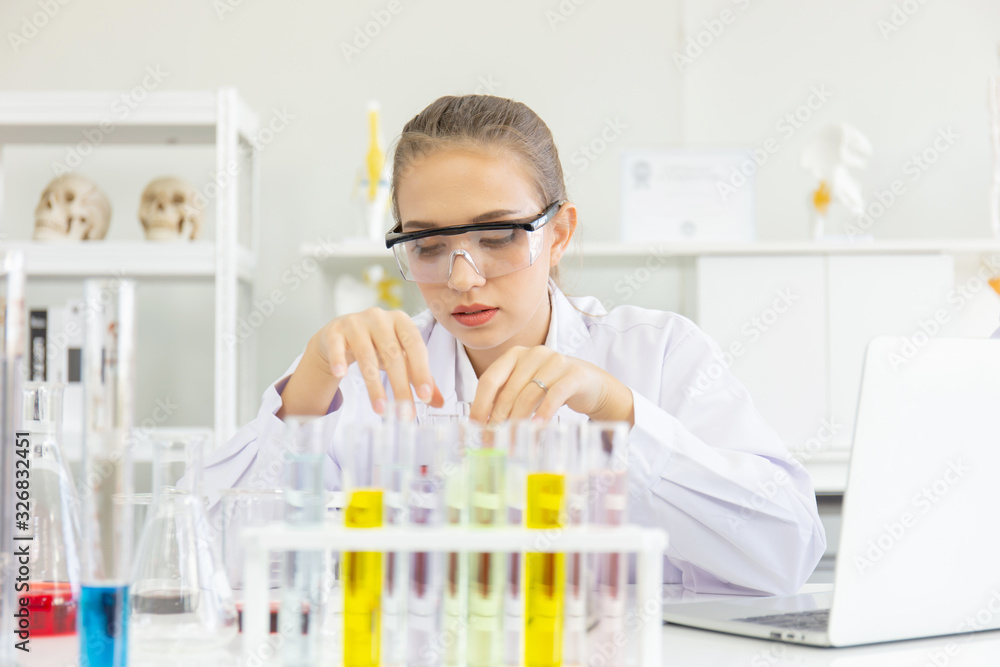 Poster A young female scientist is operating in a science lab with various equipment in the lab.