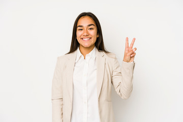 Young woman isolated on a white background showing victory sign and smiling broadly.