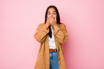 Young mixed race indian woman isolated shocked covering mouth with hands.