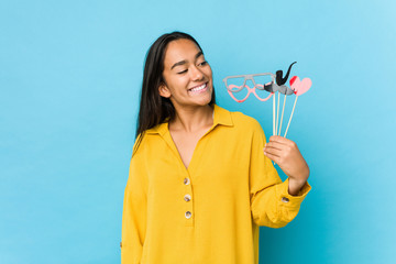 Young indian woman having fun and  holding a party objects isolated
