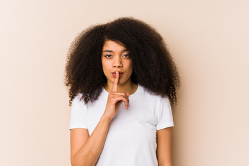 Fototapeta na wymiar Young african american woman keeping a secret or asking for silence.