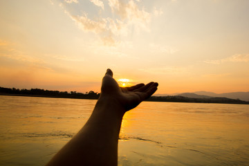 hand with sunset