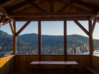 View from the gazebo in the ski resort Gornaya Salanga. Beautiful landscape with coniferous forest. Winter day in Siberia