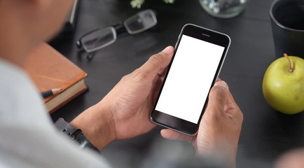 Cropped shot view of woman hands holding smart phone with blank copy space screen for your text message or information content, female reading text message on cell telephone during in urban setting.
