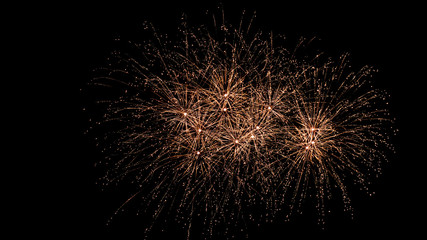 Obraz premium White and yellow fireworks in the night sky isolated on black background