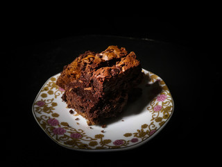 Chocolate brownie isolated on black background
