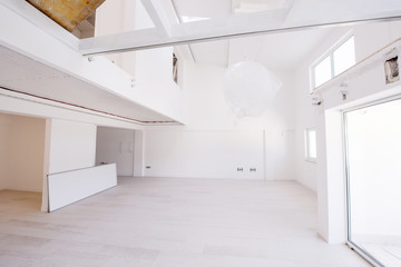 Interior of empty stylish modern open space two level apartment