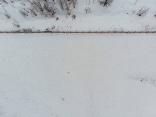 View from top of a fence cutting through a snow field, providing empty space for words and quotesView from top of a fence cutting through a snow field .