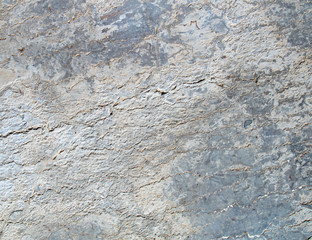 Granite stone wall texture with blue tint, background.