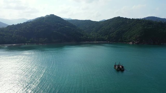 Boats floating in calm emerald waters, Thailand lagoon on sunny summer day