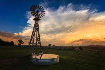 windmill at sunset before a storm